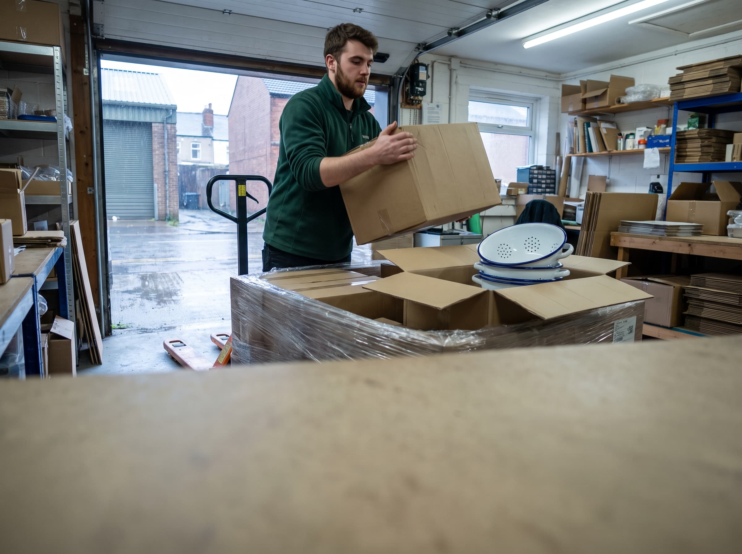 Warehouse worker unpacking a delivery from a pallet